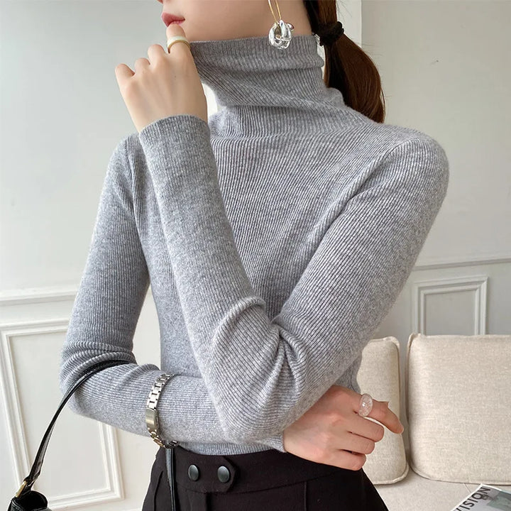 Classic women's slim fit turtleneck sweater in a fine knit, offering elegant style and versatile winter layering.
