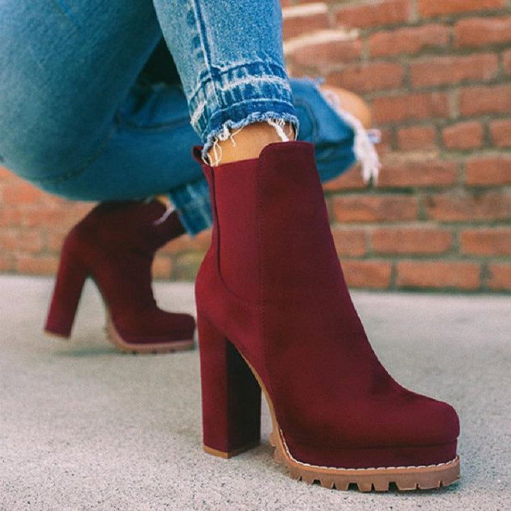 Women's slip-on platform ankle boots with block heel. Fashionable suede-look design for fall/winter chic footwear.