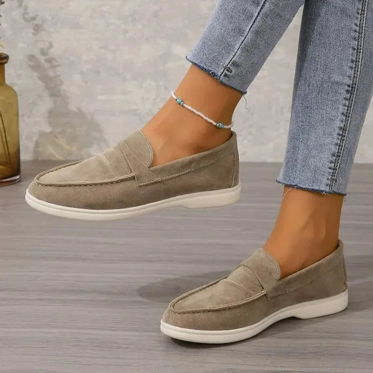 Classic women's black slip-on loafers, offering cushioned comfort for office & casual style.