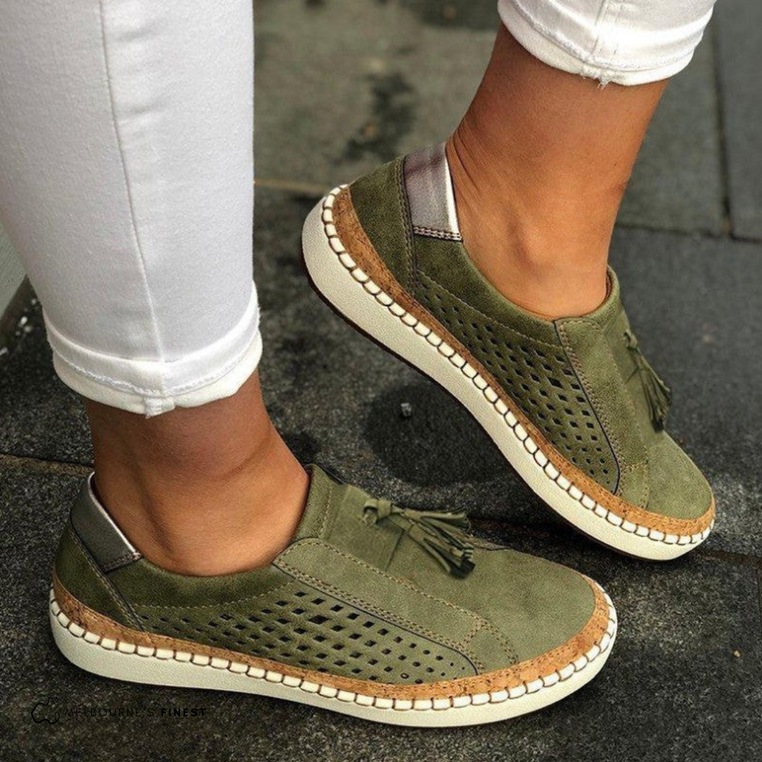 Stylish women's perforated tassel loafer flats, ideal for summer. Easy slip-on design offers versatile comfort.