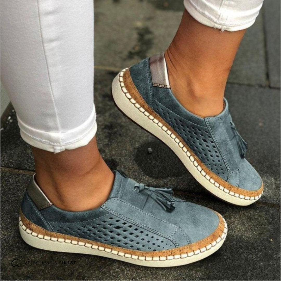 Comfortable women's perforated slip-on flats with chic tassel detail. Breathable loafers for versatile daily wear.