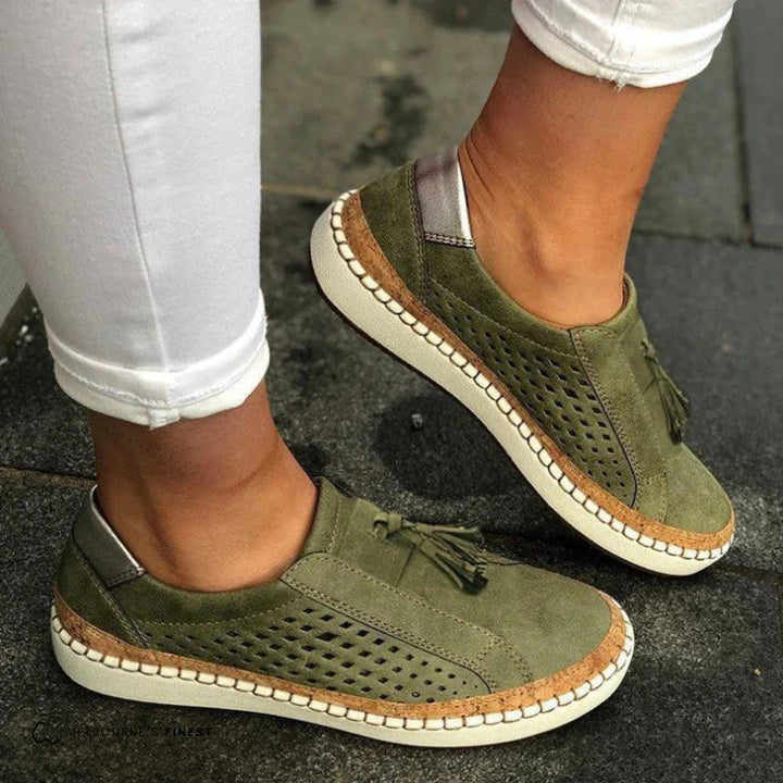 Women's slip-on perforated sneakers with stylish tassel detail for casual spring fashion.