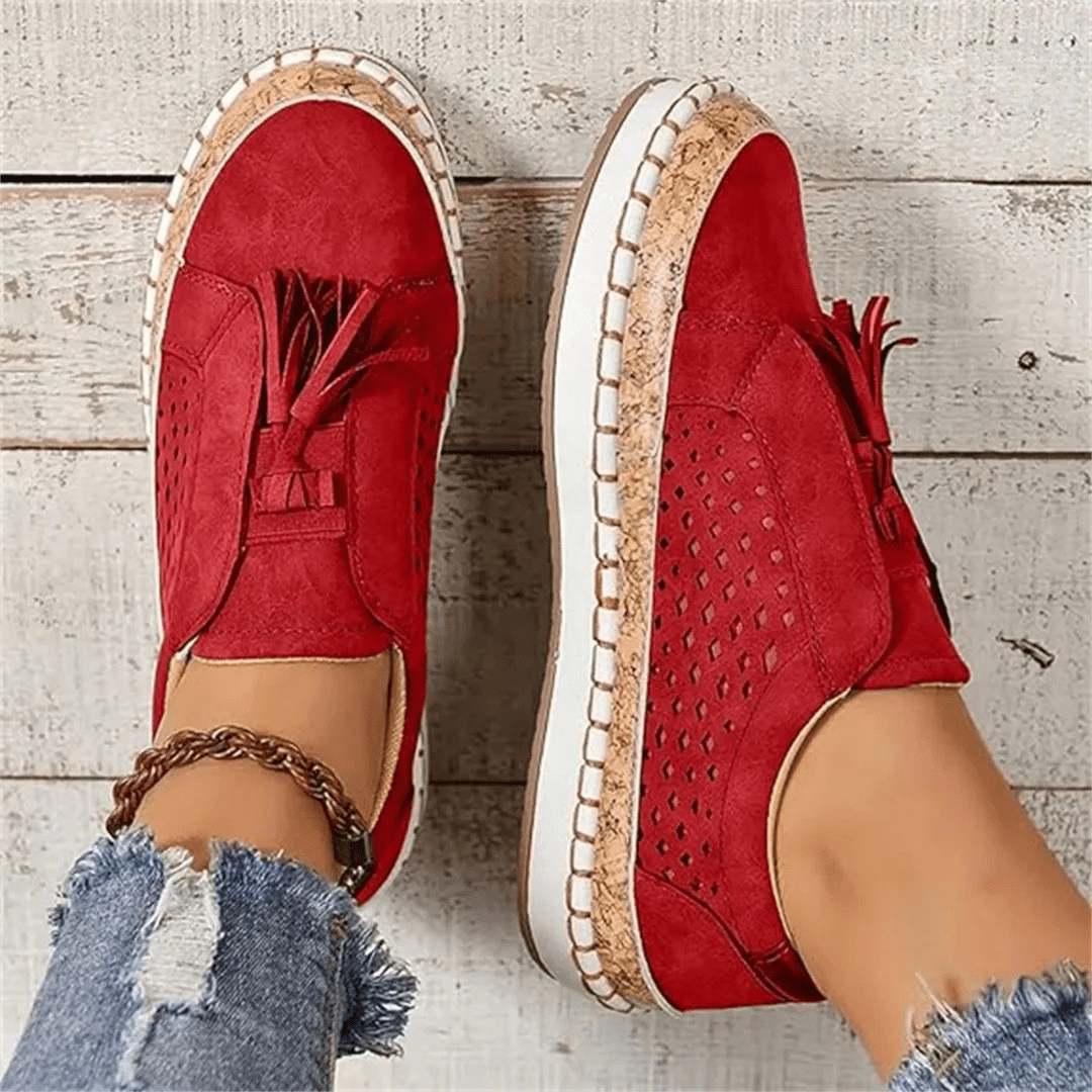Textured perforated women's slip-on sneakers with fun tassel detail, ideal for everyday casual wear.