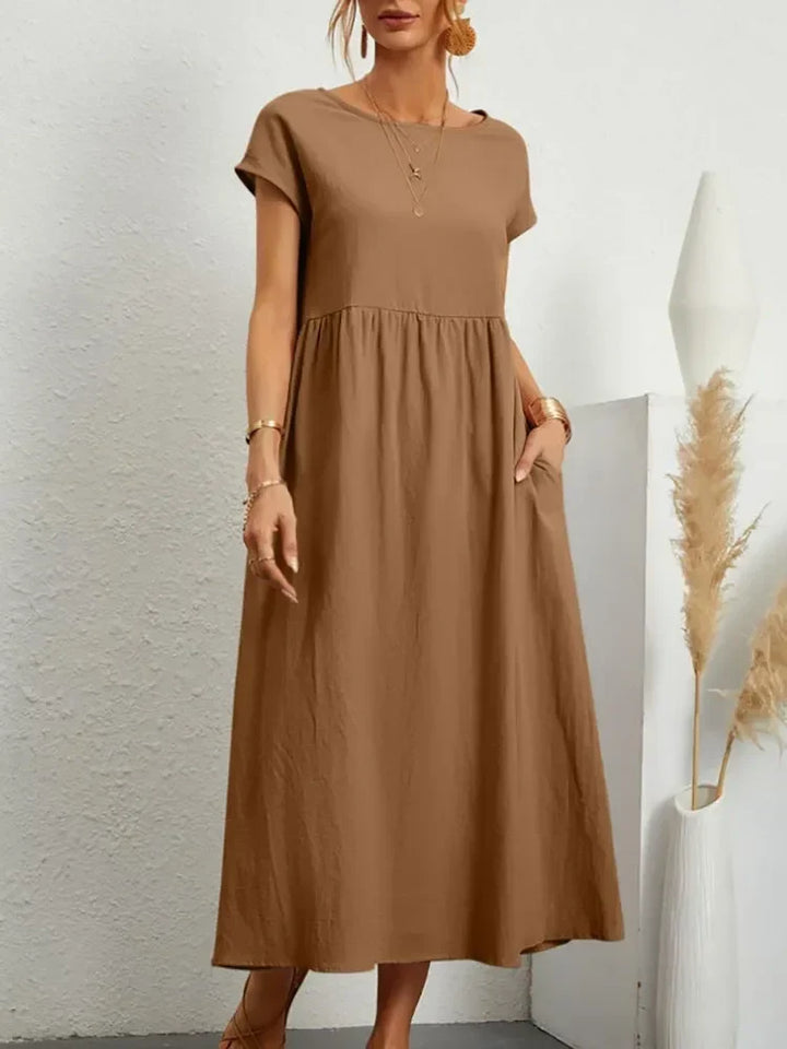 Comfortable women's everyday maxi dress featuring a flattering smock waist and practical short sleeves.