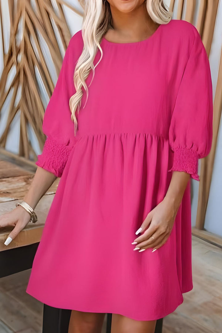 Flared babydoll mini dress for women, featuring smocked half sleeves and charming ruffle details.