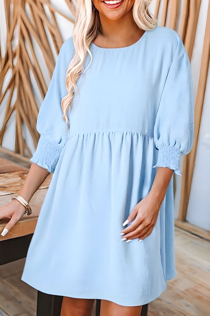 Women's mini babydoll dress, ideal for spring/fall, with smocked half sleeves & a cute ruffled hem.