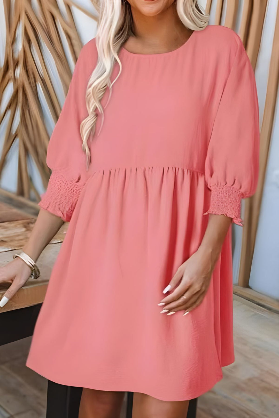 Flattering women's babydoll mini dress with a flared skirt, smocked half sleeves & playful ruffles.