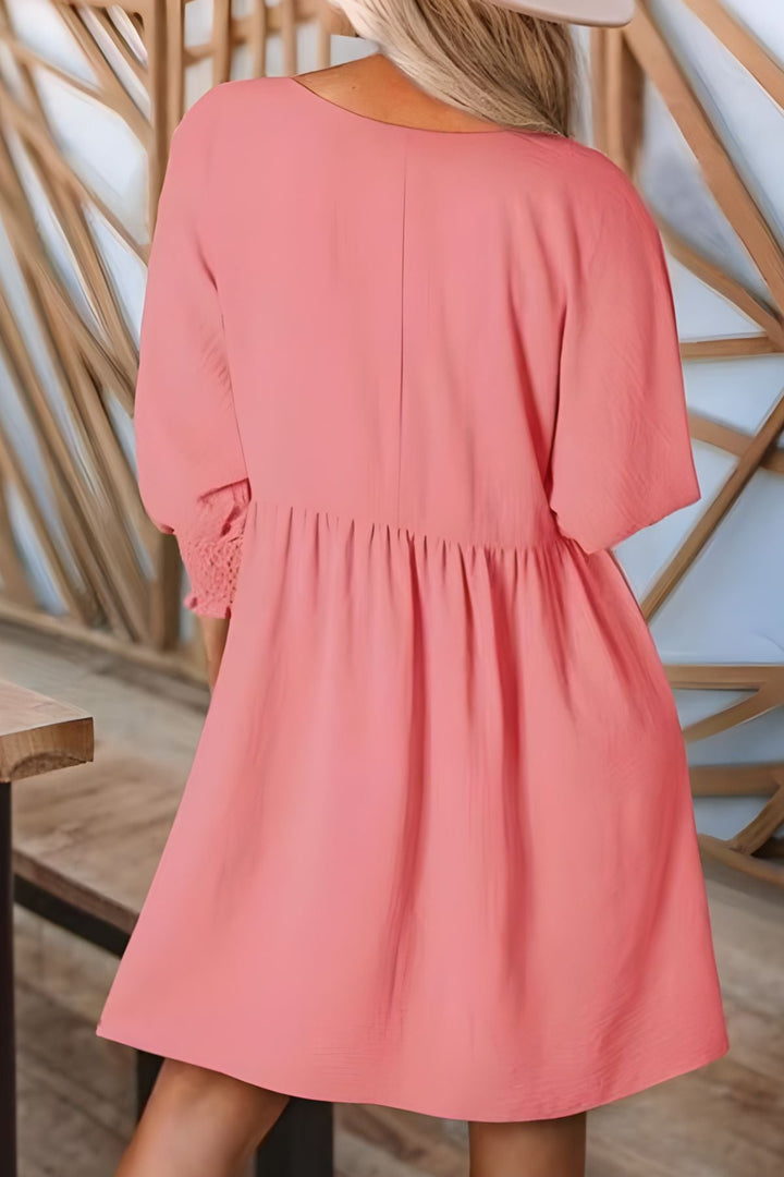 Trendy women's half-sleeve babydoll mini dress, smocked cuffs, ruffled design, perfect casual look.