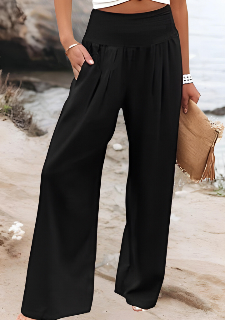 Close-up of women's smocked high waist pants, highlighting the comfortable wide leg and flowy fabric.