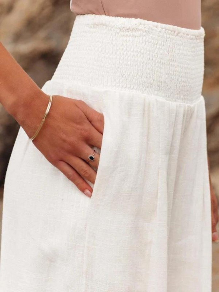 Relaxed fit women's high waist wide leg pants with smocked detail, offering effortless comfort and chic style.