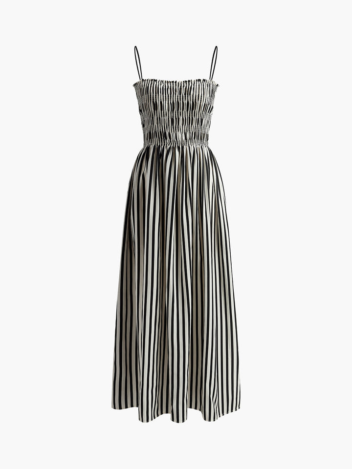 Women's pinstripe maxi dress with smocked bodice and thin straps, ideal for warm weather.