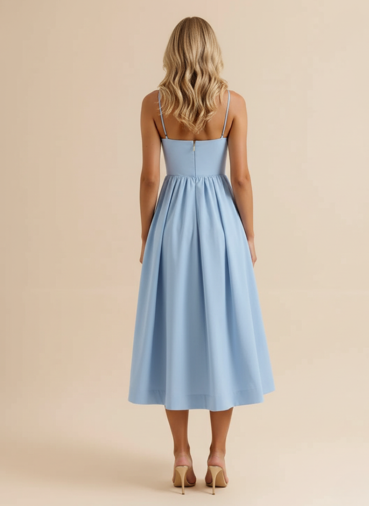Casual chic women's spaghetti strap midi dress with scoop neck. An elegant A-line design for summer parties.
