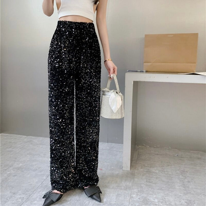 Glimmering women's high-waist party pants, featuring a sparkling finish for an eye-catching, festive evening outfit.