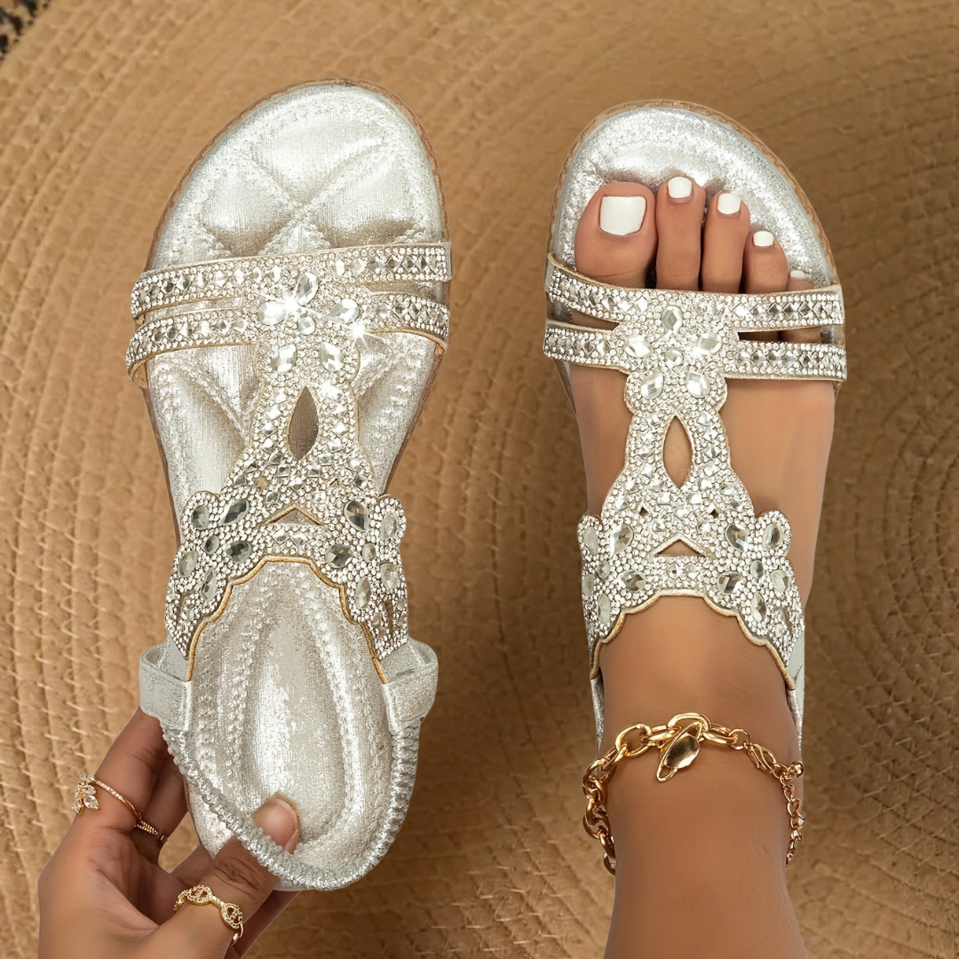Stylish women's flat summer sandals with shimmering rhinestone details for fashion footwear.