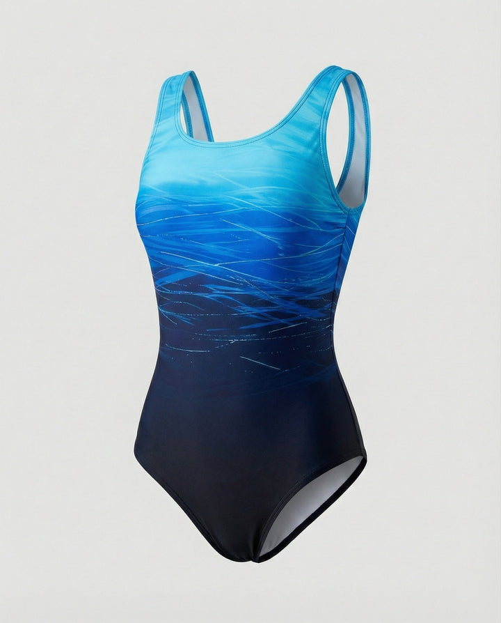 Woman in a vibrant ombre one-piece swimsuit, quick-dry sporty activewear, enjoying beach activities.