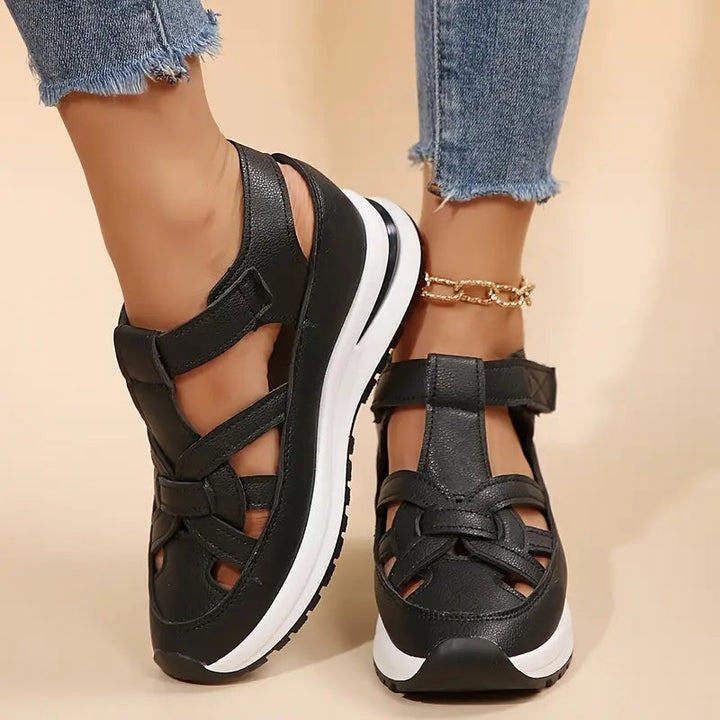 Black women's sporty platform sandals featuring unique cutout straps, perfect casual summer footwear.