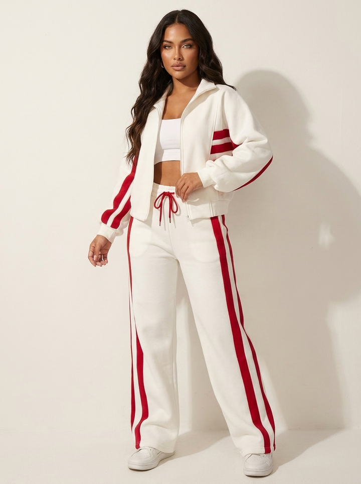 Comfortable women's two-piece lounge wear tracksuit with chic contrast stripe design, ideal for relaxing.