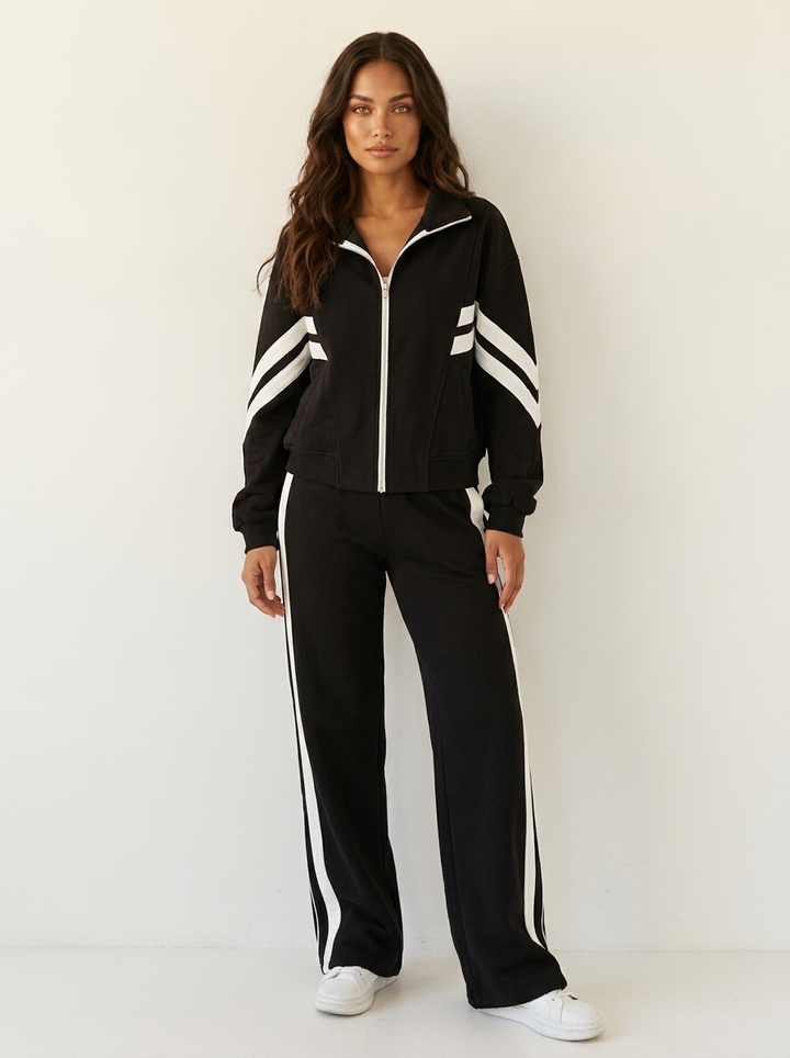 Athletic women's coordinated tracksuit set, features a stylish contrast stripe jacket & wide leg trousers.