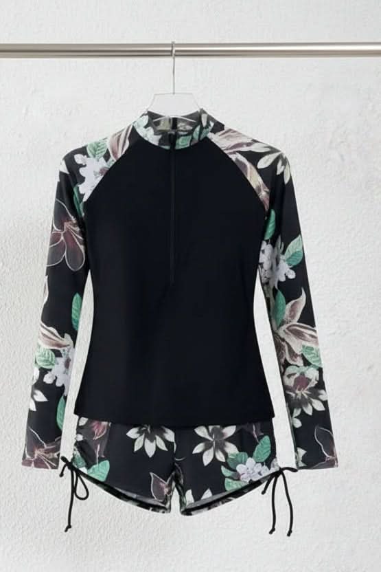 Sporty women's rashguard set with a colorful tropical print, designed for sun protection and active beach days.