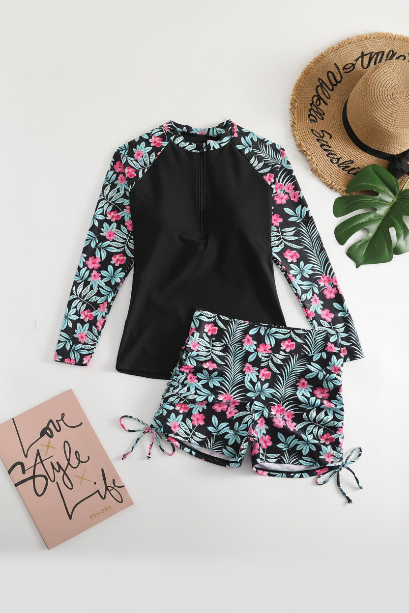 Active women's rashguard swimwear set with vibrant tropical print, perfect for water sports and sun-filled vacations.