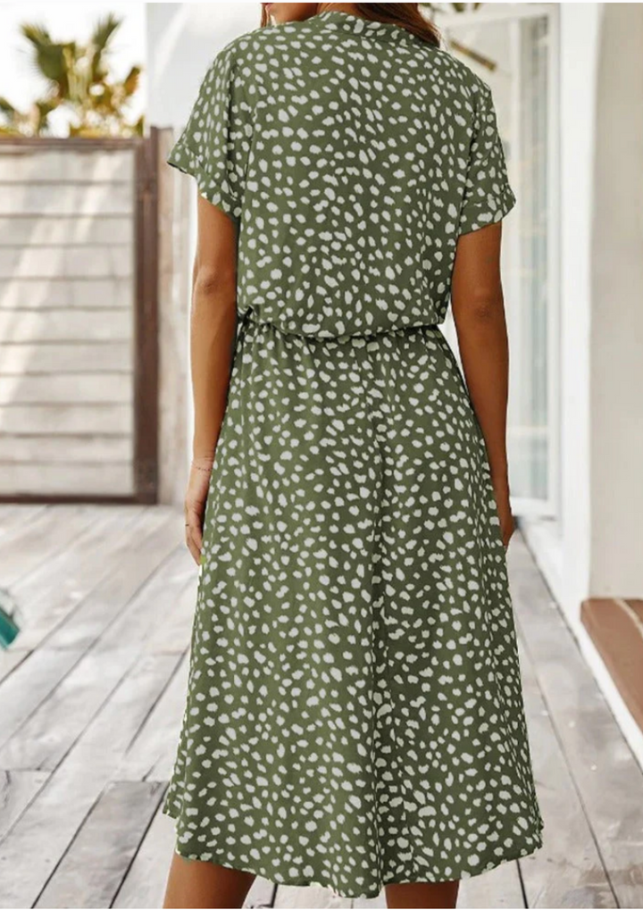 Chic spotted print women's midi dress, V-neck, button front, and a flattering flowy design. Spring fashion.