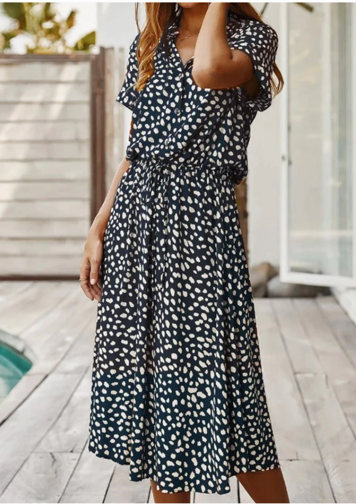 Comfortable women's spotted midi dress with a V-neck, button-down front, and an adjustable drawstring waist.