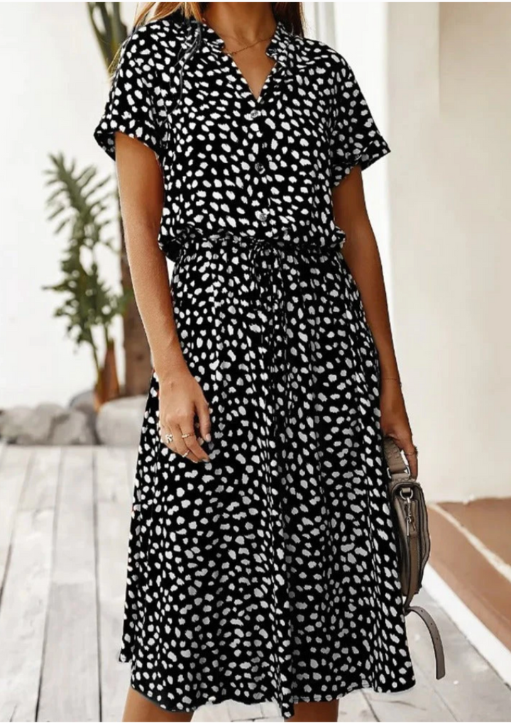 Elegant spotted print midi dress with button-front V-neck and delicate flutter sleeves. Ideal summer dress.