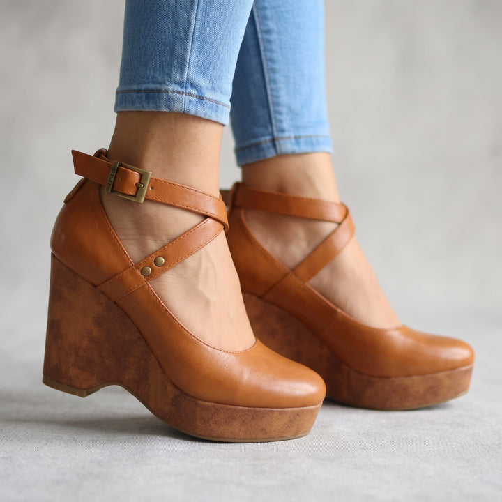 Chic women's platform wedge sandals with elegant cross-front straps, perfect for versatile summer outfits.