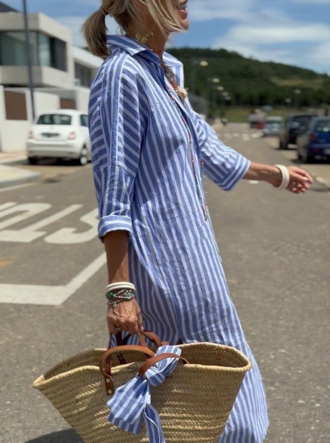 Flowy women's striped midi shirt dress. Button front & relaxed fit for a comfortable, stylish summer vacation outfit.