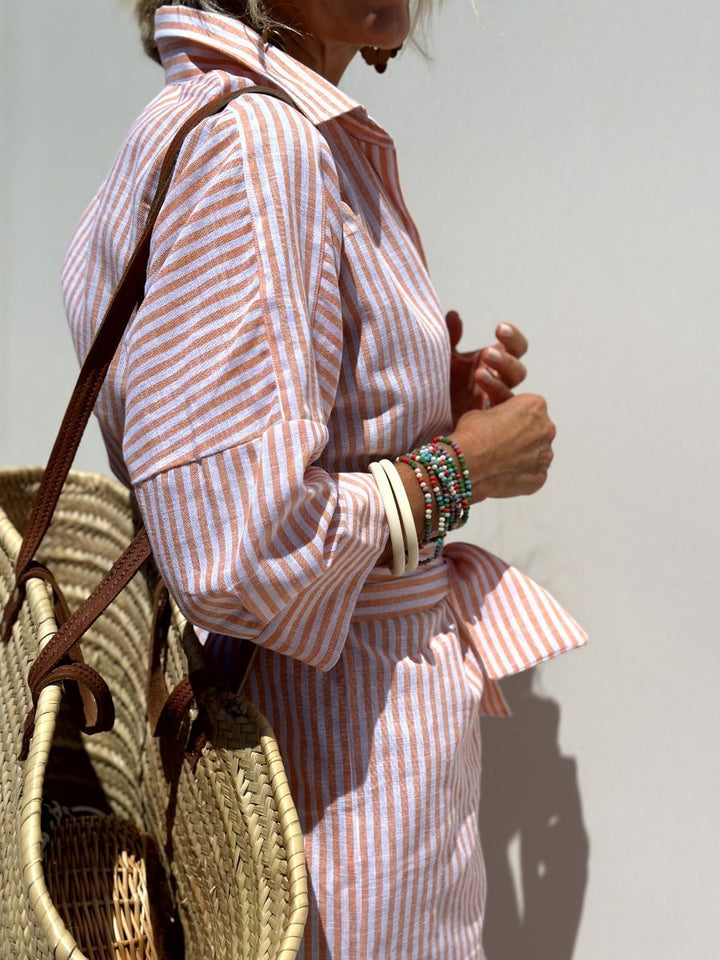 Chic women's striped midi shirt dress. Relaxed fit & button front offer comfort & fashion for any casual day.