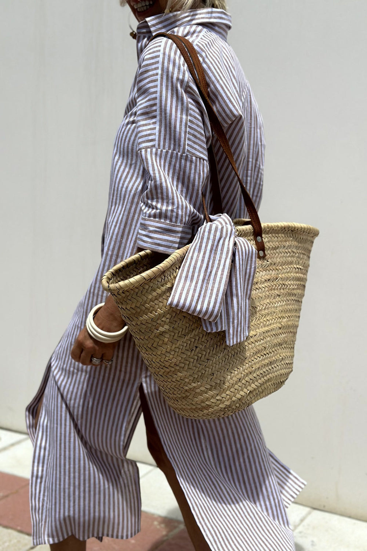 Fashionable striped midi shirt dress for women, collared and buttoned, offering a chic and relaxed oversized look.