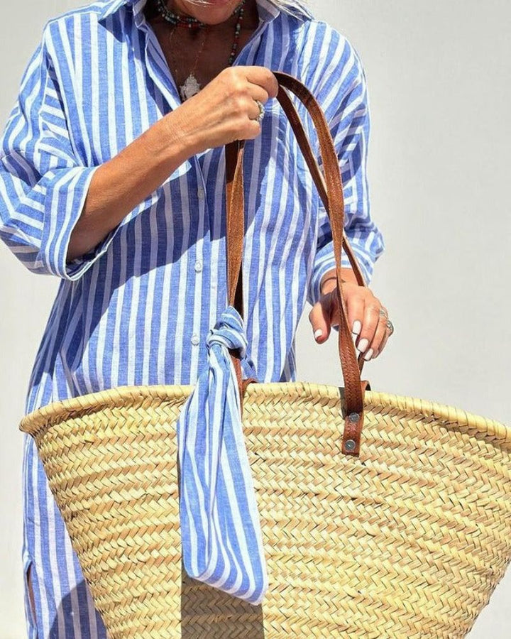 Stylish women's striped midi shirt dress, button-front design with handy pockets for effortless fashion.