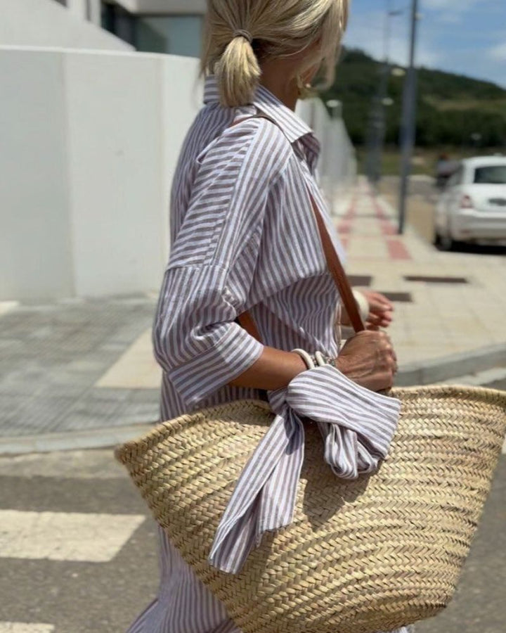Chic striped midi shirt dress for women, featuring a full button closure and convenient side pockets.