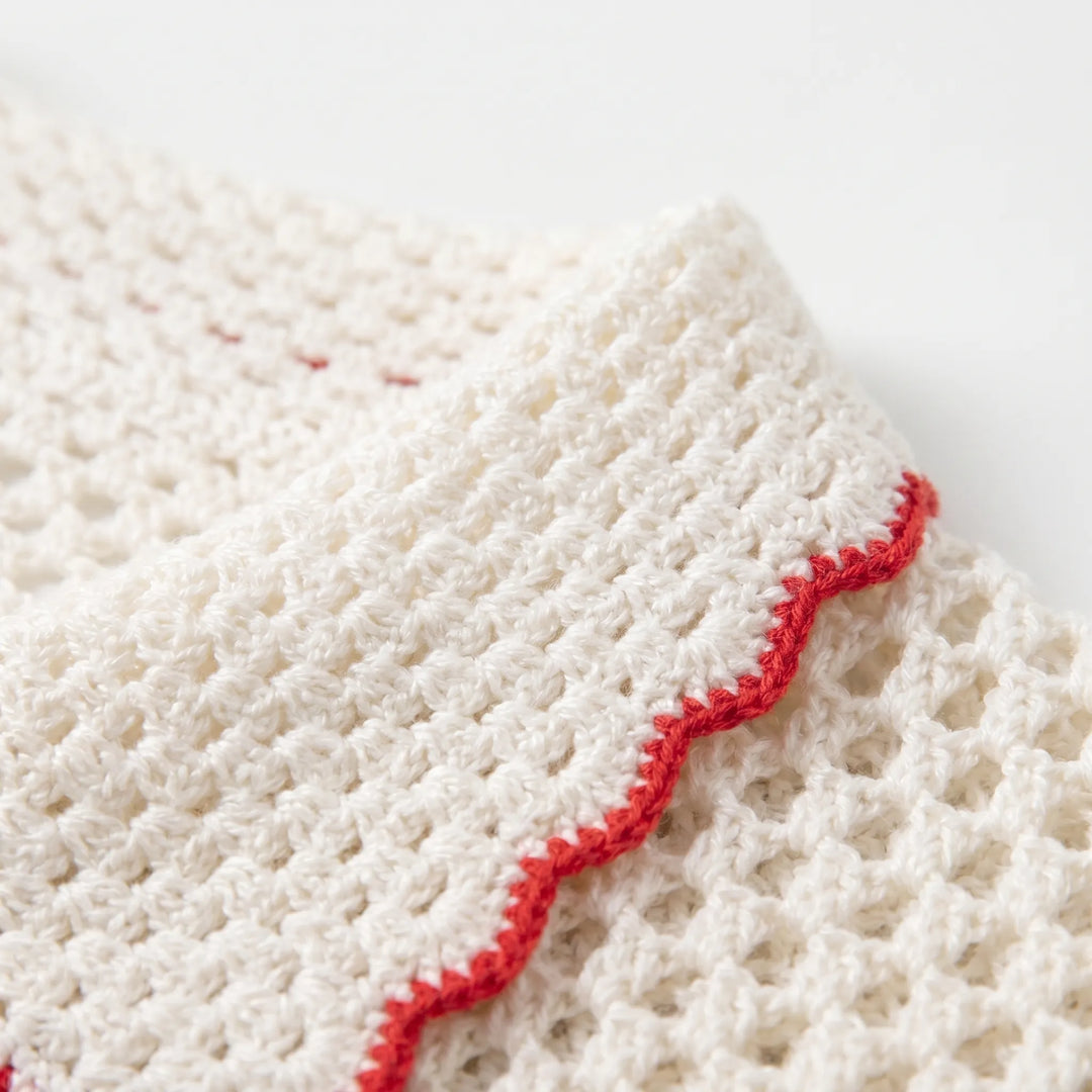 Detailed view of a women's short-sleeve striped open-knit cardigan, highlighting its texture.