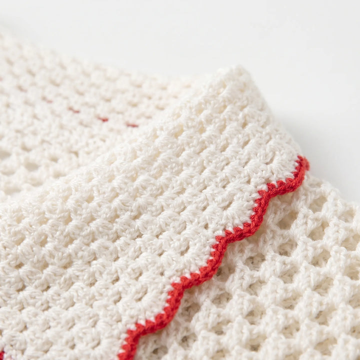 Detailed view of a women's short-sleeve striped open-knit cardigan, highlighting its texture.