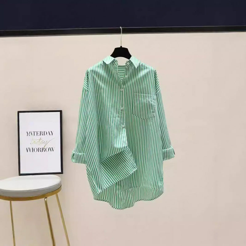 Striped women's oversized button-down shirt featuring a longline cut, collar, and chest pocket.
