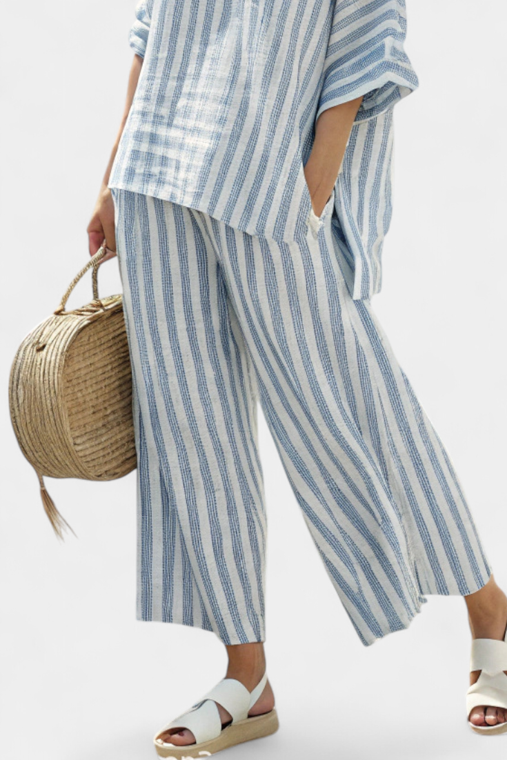 Comfortable women's striped two-piece set featuring an oversized top & wide-leg pants. Perfect for summer resort wear.