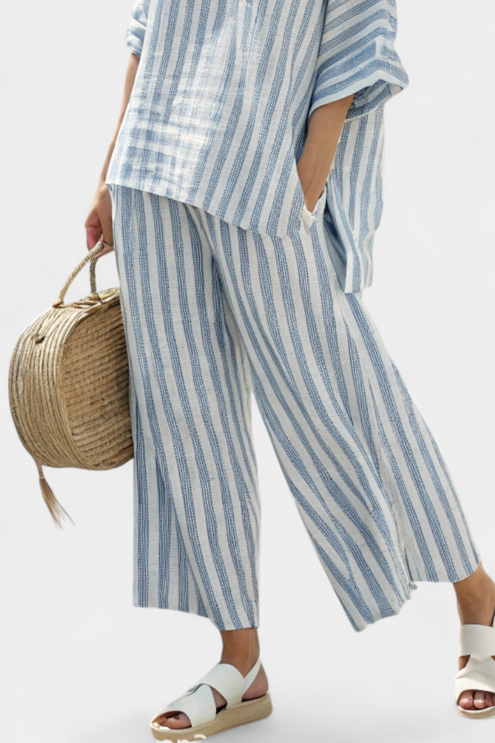 Comfortable women's striped two-piece set featuring an oversized top & wide-leg pants. Perfect for summer resort wear.