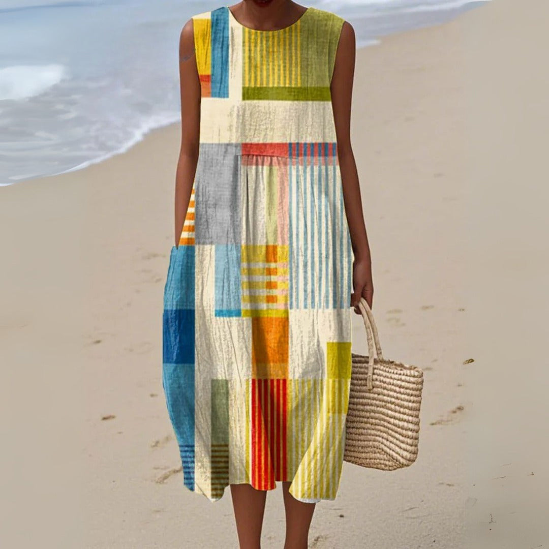 Women's striped patchwork midi dress with a relaxed fit, sleeveless design, and pockets, perfect for casual summer wear.