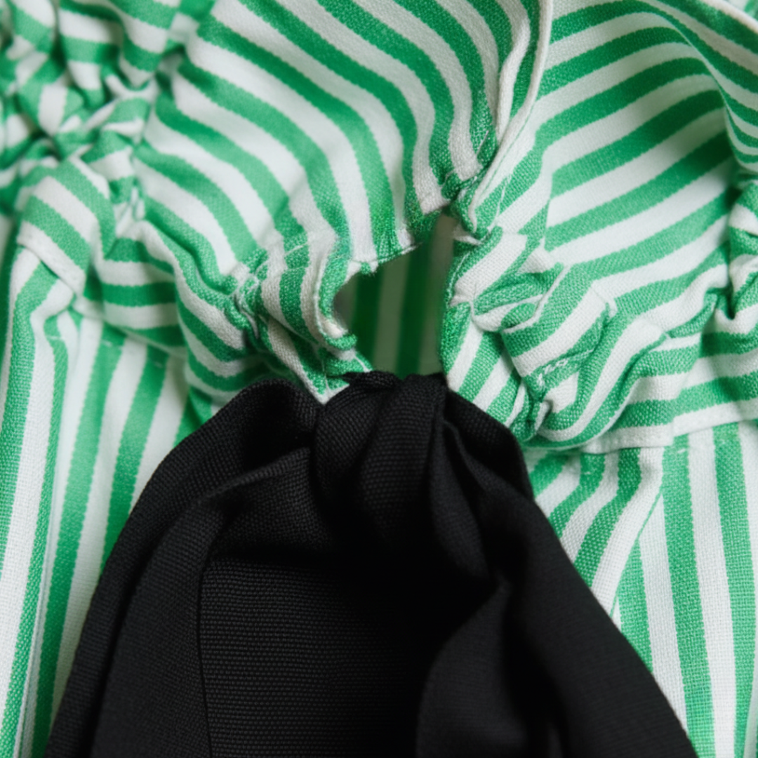 Modern women's striped blouse with balloon sleeves, ruffled neckline, and a stylish bow tie. Relaxed fit.
