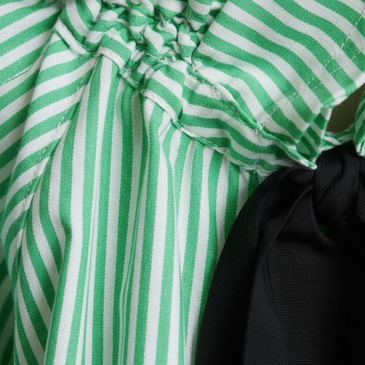 Elegant ladies striped blouse. Ruffle trim, bow tie, and balloon sleeves for chic, versatile office wear.