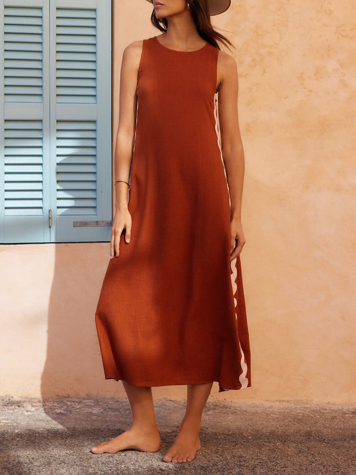 Elegant striped midi sundress with a stylish side slit, ideal for summer fashion and casual daywear.