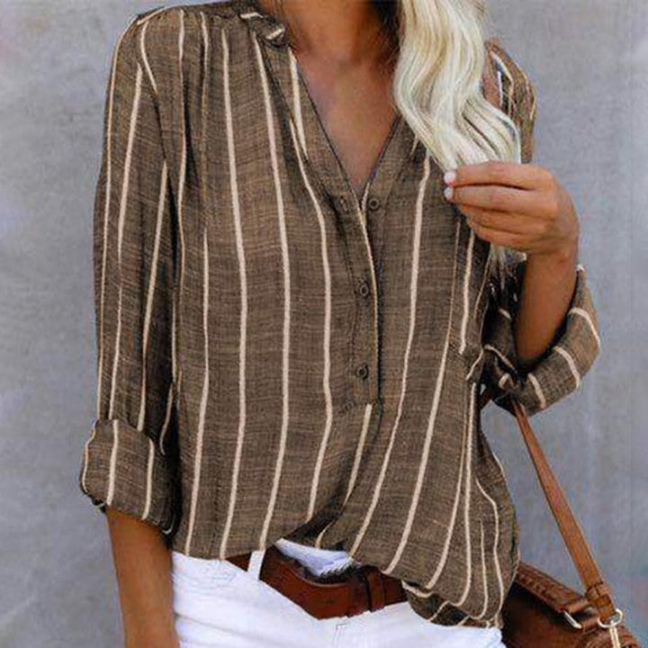 Women's striped V-neck blouse with roll-tab long sleeves. Casual elegant fashion top for versatile womenswear.