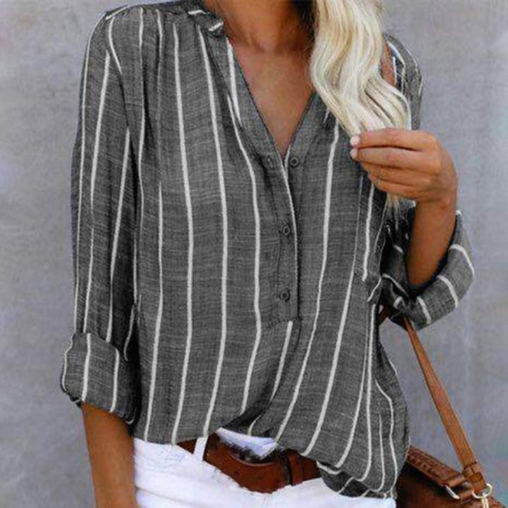 Elegant striped V-neck shirt for women, featuring button-down front and versatile roll-tab long sleeves.