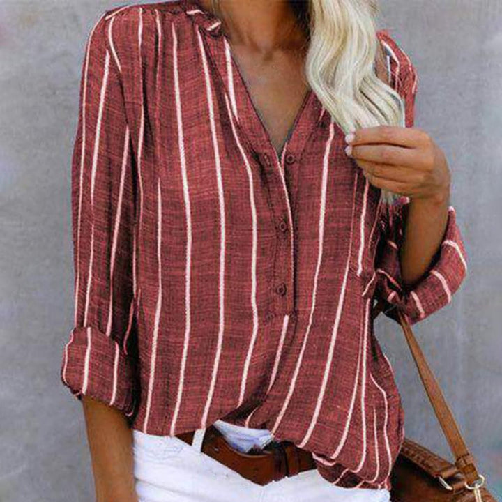 Stylish women's striped top with a flattering V-neck and practical roll-tab sleeves. Comfortable casual blouse.