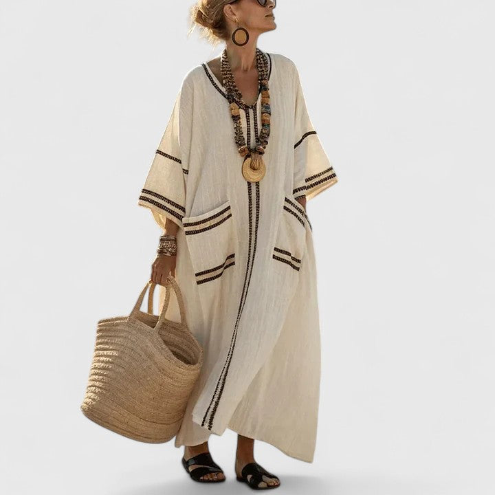 Flowy women's striped maxi dress with V-neck, ideal for casual summer outings or bohemian style.