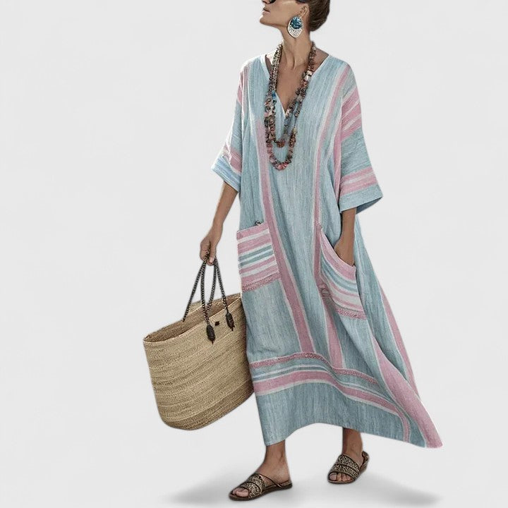 Women's striped V-neck maxi dress with pockets. Comfortable, flowy design for summer casual or resort wear.