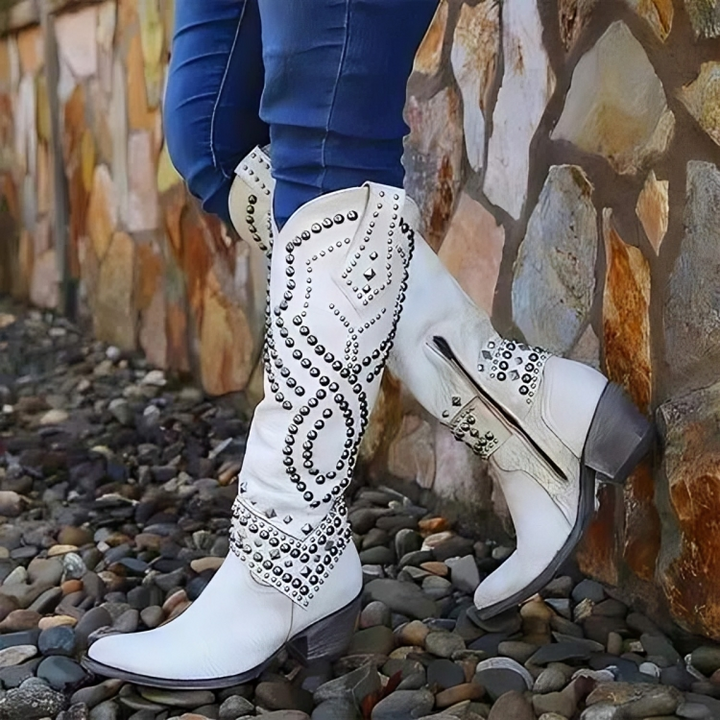 Edgy women's studded knee-high western cowboy boots with pointed toe; ideal as statement shoes or festival wear.