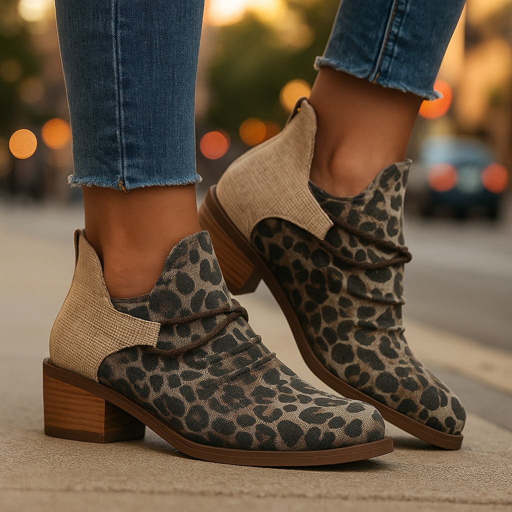 Denim blue women's ankle boots featuring unique braided and lace-wrap accents. Stylish block heel.