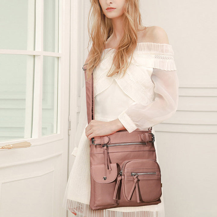 Stylish women's messenger bag with anti-theft features, adjustable strap, ideal for travel.